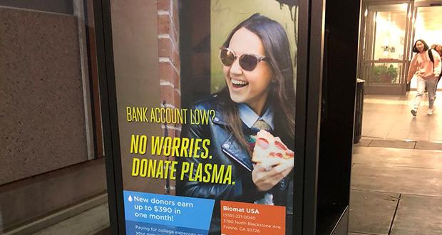 An advertisement outside of Fresno State’s Henry Madden Library suggesting students to donate plasma if they are in financial need. University English professor Randa Jarrar tweeted criticism for the advertisement on Nov. 29, 2017. Photo courtesy of Jarrar’s Twitter account.