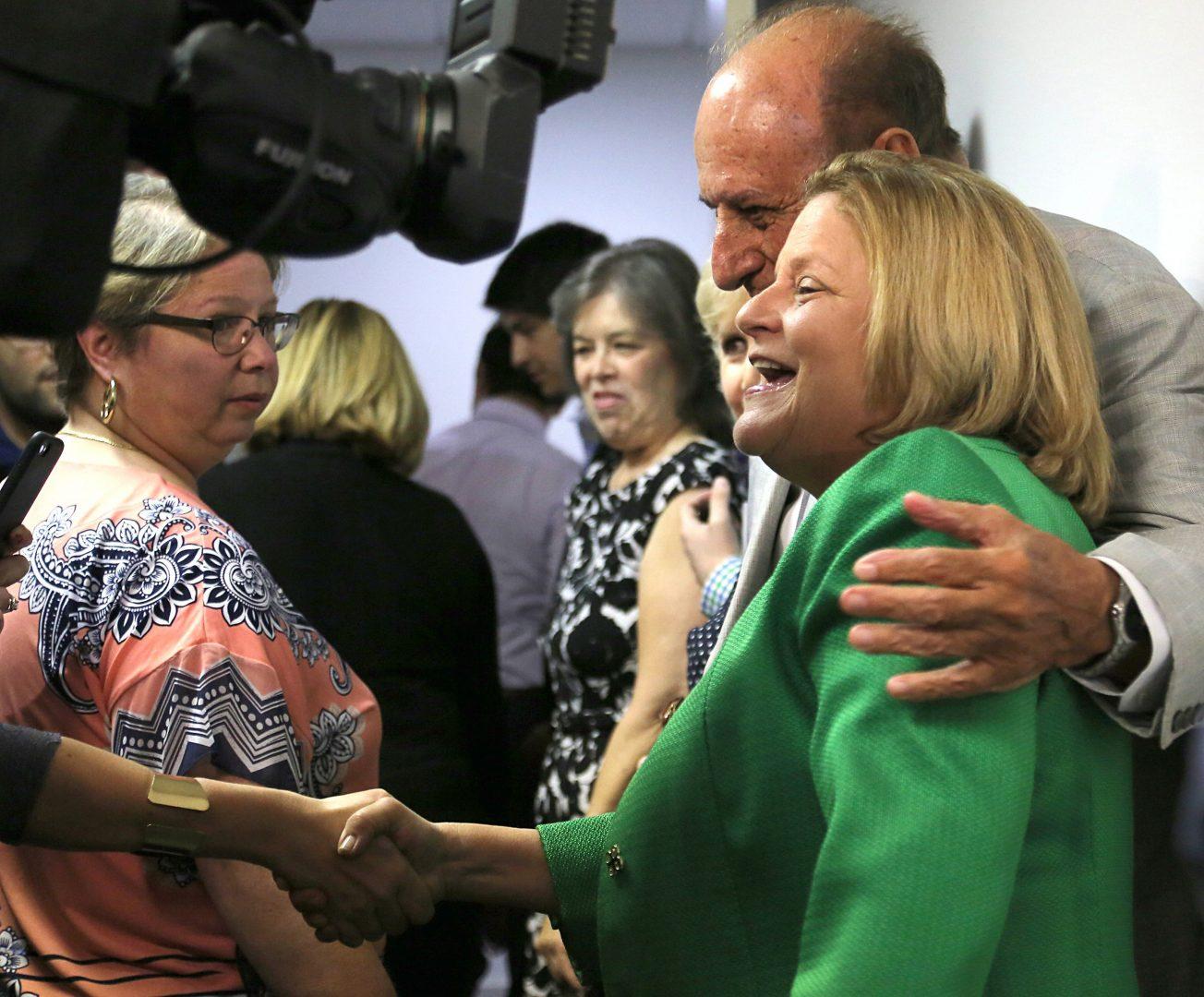 U.S. Rep. Ileana Ros-Lehtinen, right, shakes hands with well-wishers after giving a statement regarding her retirement from Congress on May 1, 2017, in Miami, Fla. (Carl Juste/Miami Herald/TNS)
