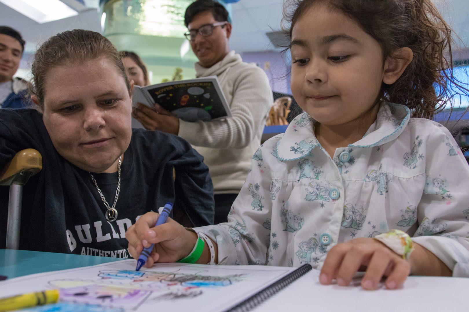 Valley Children’s patient Maddlyn begins using her new crayons and a coloring book that she received from Dr. Tamrya Pierce’s MCJ 106 students at Valley Children’s hospital, on Nov. 17, 2017. (Alejandro Soto/ The Collegian)