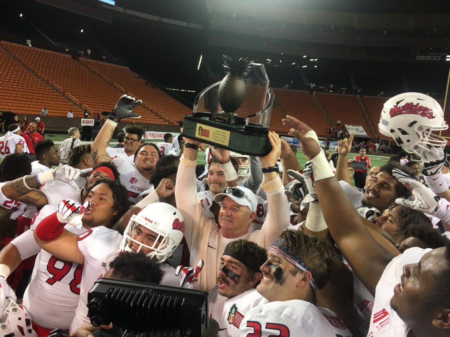 Coach Jeff Tedford and the Fresno State football team celebrating their Hawaii Bowl win against the Houston Cougars, 33-27 at Aloha Stadium on Dec. 24. (Fresno State Athletics) 