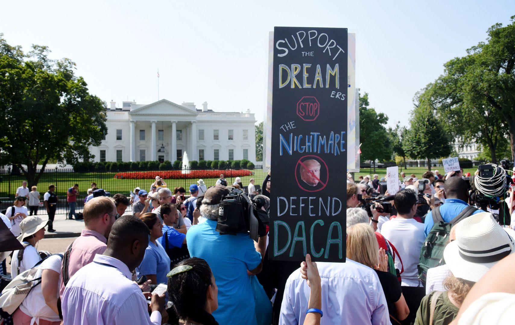 Protesters hold up signs during a rally supporting Deferred Action for Childhood Arrivals, or DACA, outside the White House on September 5, 2017. Federal immigration authorities have resumed accepting requests for renewals in DACA, the Obama administration program that shielded hundreds of thousands of young immigrants from being deported. (Olivier Douliery/Abaca Press/TNS)
