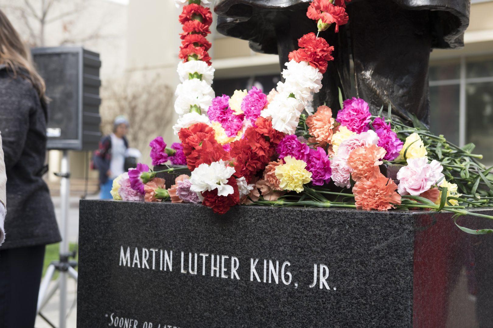 The flowers left by attendees of the Dr. Martin Luther King Jr. Commemoration at the Peace Garden on Thursday, Jan. 18, 2018. (Ramuel Reyes/The Collegian)