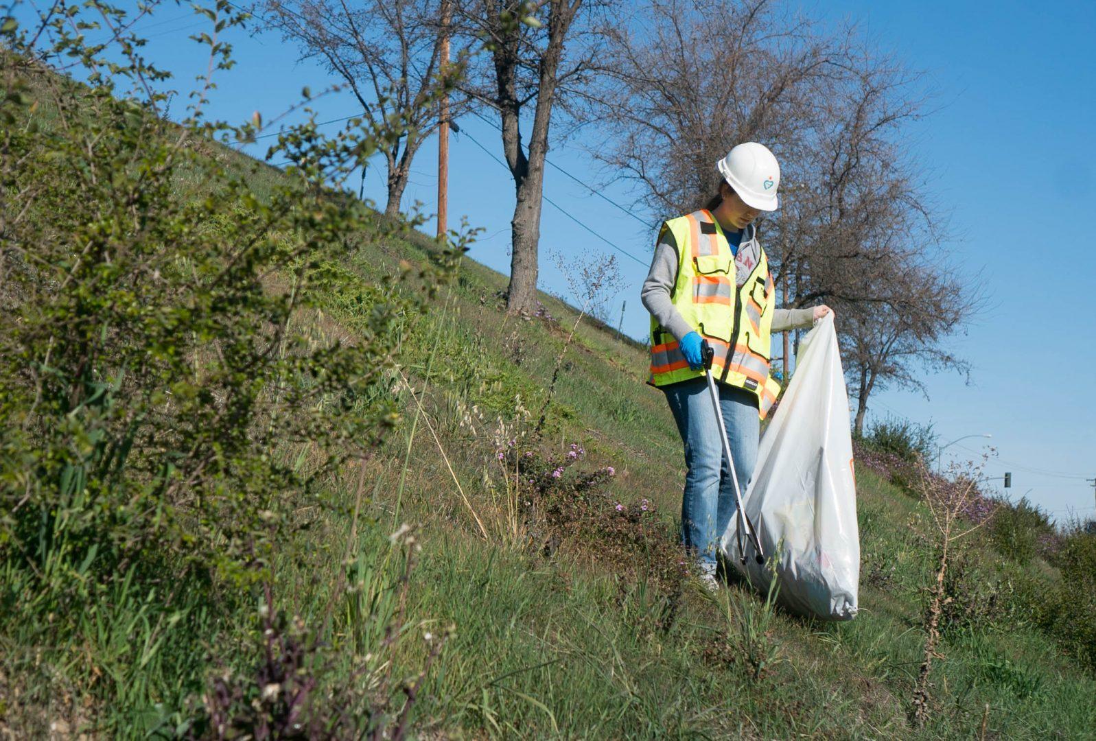 Mechanical engineering student Emma Van Fossen picks up trash along Highway 168 for the Adopt-a-Highway volunteer clean-up day on Feb. 24, 2018. (Aly Honore/The Collegian) 