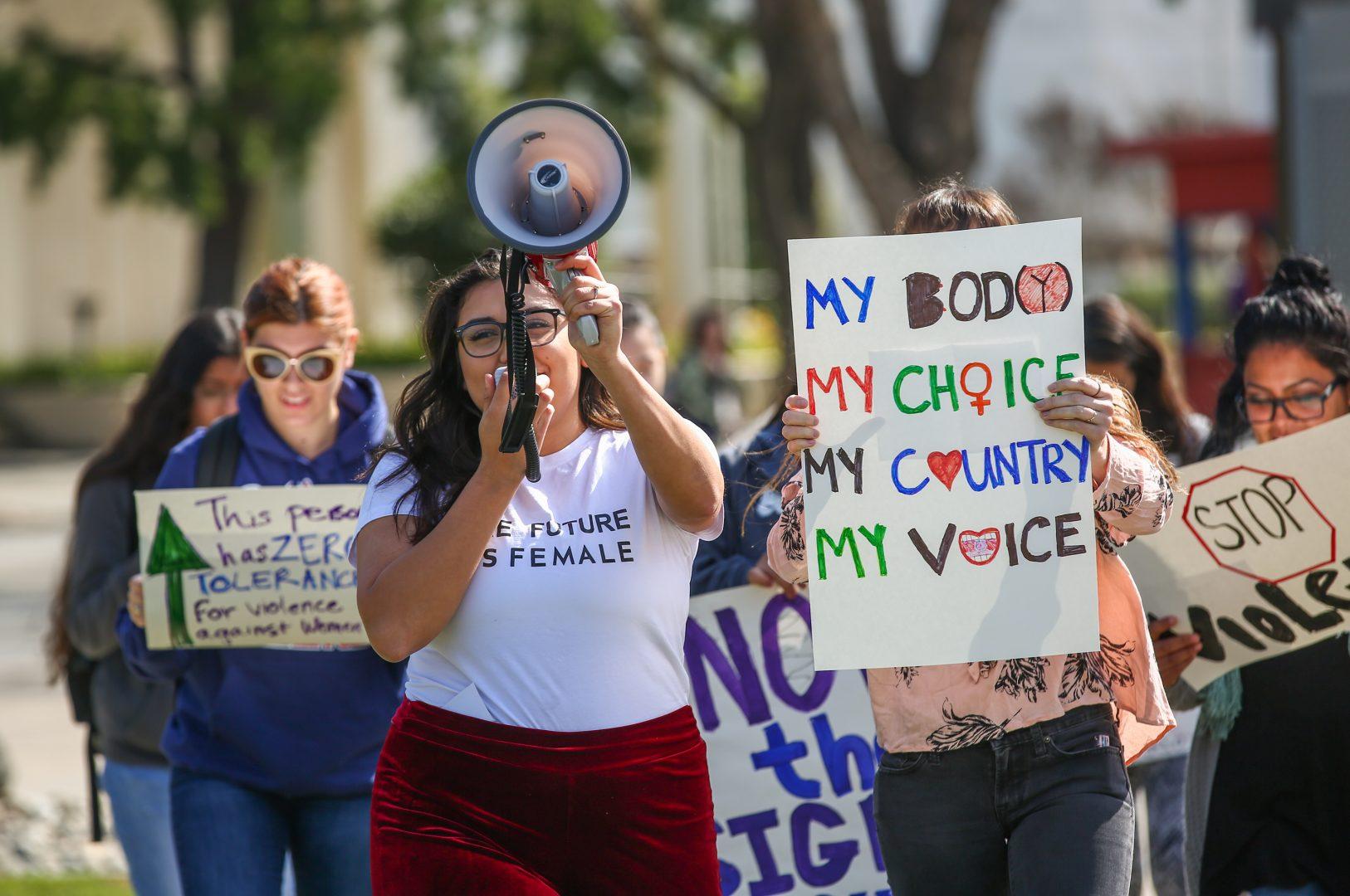 Fresno State students march through campus as part of the global One Billion Rising movement that advocates for ending violence against women.
