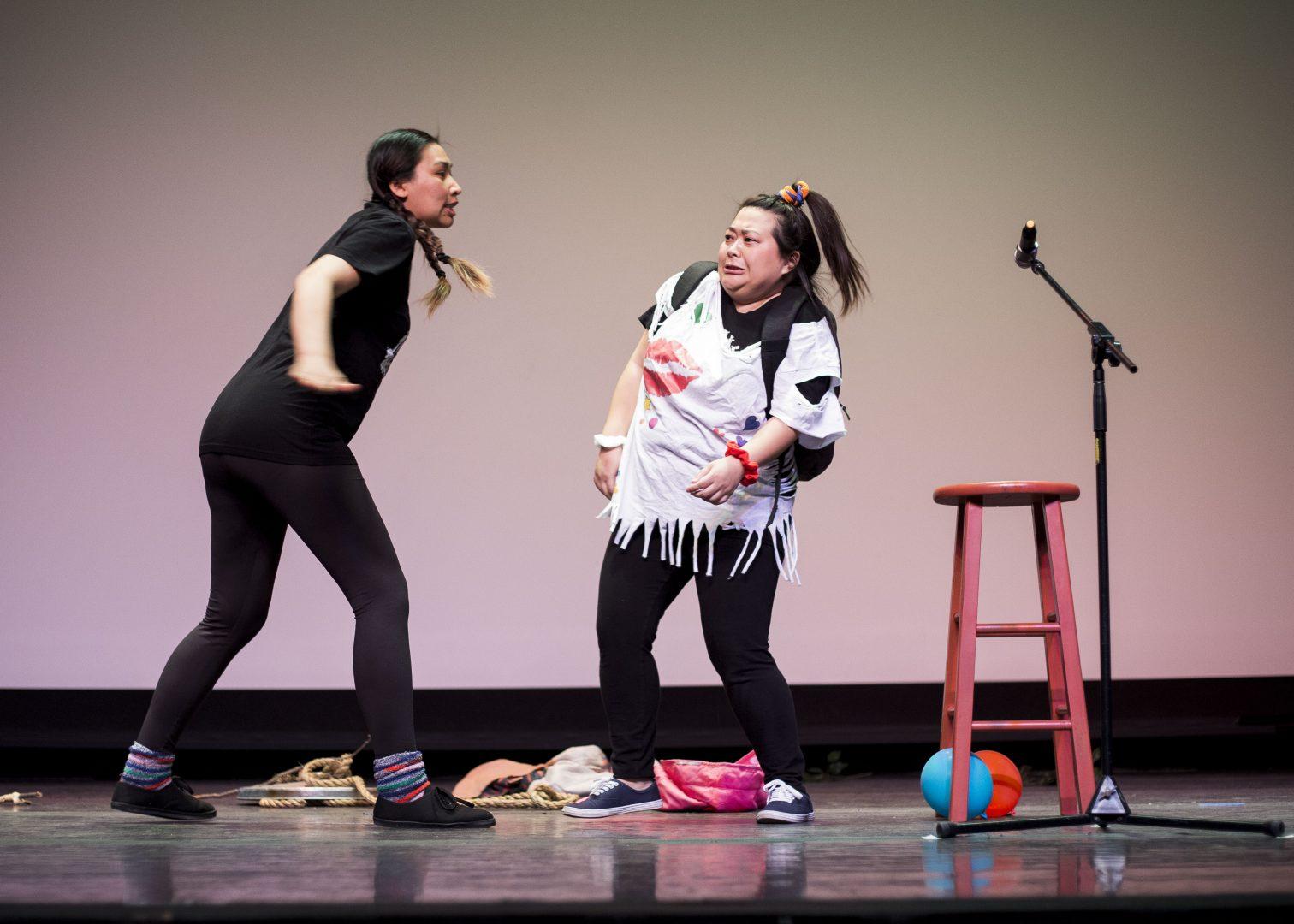 Saymoukda Vongsay and May Lee Yang re-enacts a memory from Yang’s childhood about dressing up as Madonna to school during their comedy show in the Satellite Student Union on March 11, 2018. (Ram Reyes/The Collegian)
