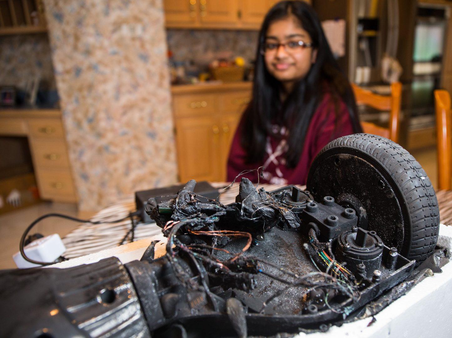 Shanna Abraham, 13, with remains of her hoverboard at home in Orland Park, Ill., on Monday, Feb. 15, 2016. The hoverboard exploded over the weekend while charging, causing minor damage to her familys home. (Zbigniew Bzdak/Chicago Tribune/TNS)