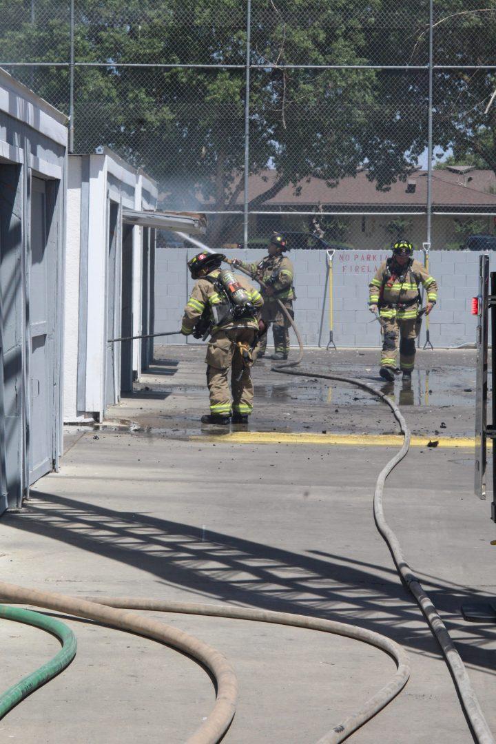 Firefighters putting out hot spots in aapartment fire at 5570 N. 10th Street June 15, 2018. Dan Waterhouse/The Collegian