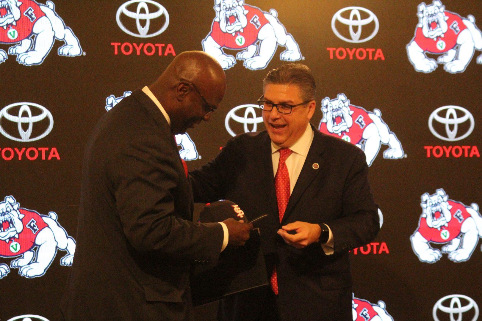 Fresno State Athletic Director Terry Tumey (left) accepts a Fresno State cap from university President Dr. Joseph I. Castro, right, on June 25, 2018. (Dan Waterhouse/The Collegian)