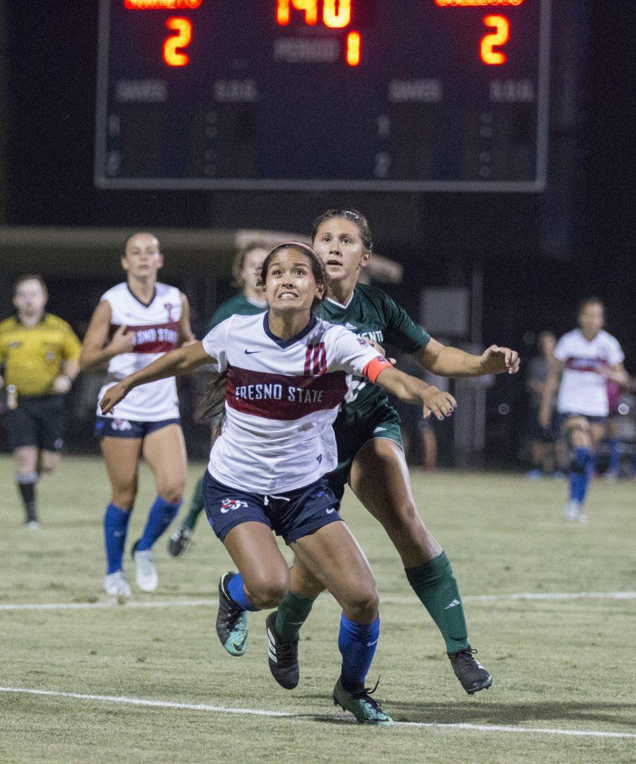Fresno State womens soccer team midfielder Alyssa Nishikawa holds off a Sacramento State opponent during a home game 2-2 draw at the Soccer and Lacrosse stadium on Friday, Aug. 24 2018. (Jose Romo/The Collegian)
