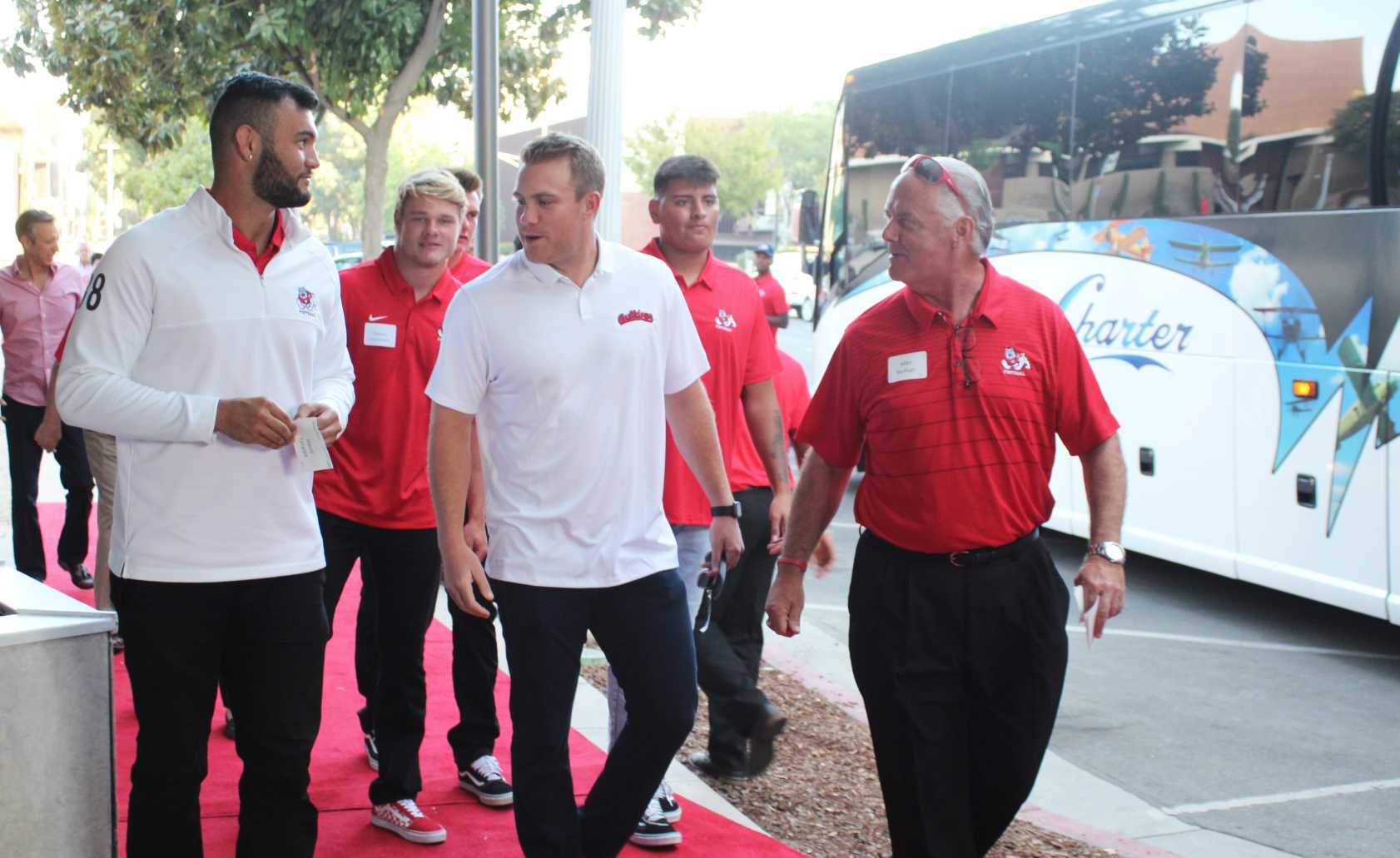 Members of the Bulldog football team entering the second annual kickoff dinner on Aug. 23, 2018 in downtown Fresno. Photo by Dan Waterhouse/The Collegian.