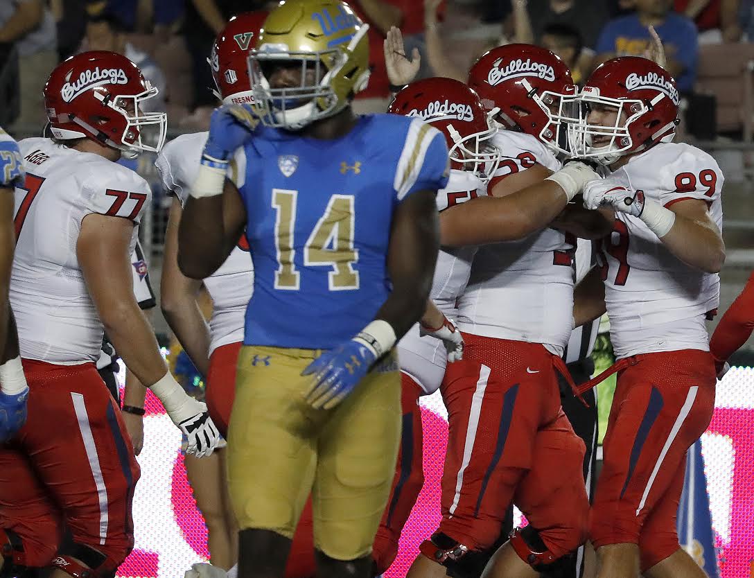 Fresno State tight end Kyle Riddering, right, is congratulated by teammates after scoring on a 10-yard touchdown catch against UCLA in the first quarter on Saturday, Sept. 15, 2018, at the Rose Bowl in Pasadena, Calif. (Luis Sinco/Los Angeles Times/TNS)