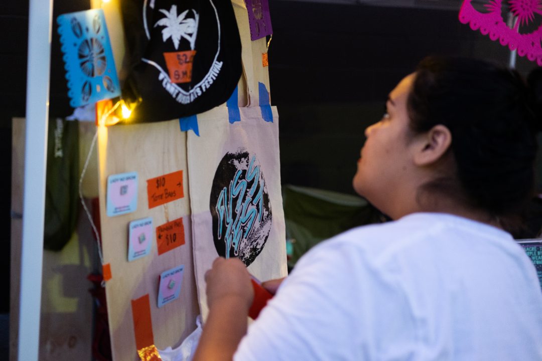 Fuss Fest creator Priscilla Van Rye fixes the merch display for her booth during the fifth annual Fuss Fest at Tioga-Sequoia Brewery on Friday, Aug 31, 2018.