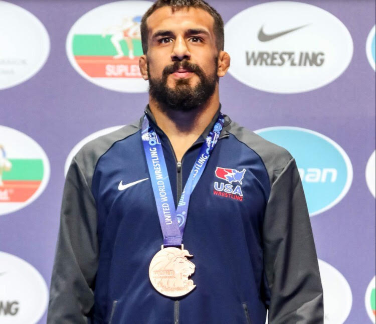 Fresno+State+volunteer+wrestling+coach+Joe+Colon+stands+at+the+podium+as+he+receives+his+bronze+medal+at+the+World+Wrestling+Championships.+Oct.+21%2C+2018+%28Photo%2F+Fresno+State+Athletics