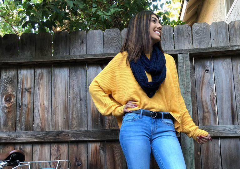 Jacqueline Ocampo models fall fashion trends such as oversized sweaters, fall colors, scarves, and light wash denim. (Marilyn Castaneda/The Collegian)