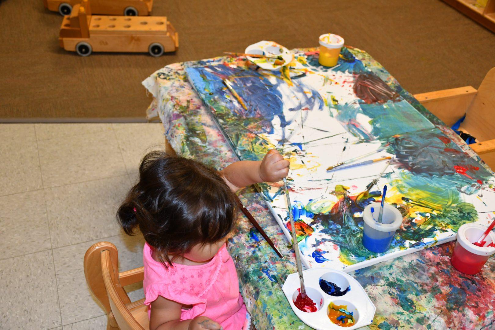A child explores with paint. Fresno State is expanding an infant center to make room for more children in an attempt to meet the growing needs of students and staff. (Connie Mosher, Master Teacher at the Joyce M. Huggins Early Education Center)