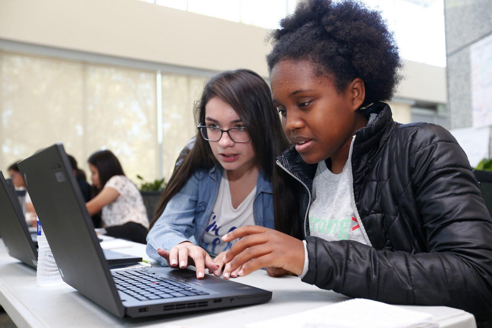 Edith Gonzalez, 16, left, and Hannah Leonard, 16, right, work together on a coding project during a summer program at Adobe Systems in San Jose, Calif., on June 28, 2016. There has been a growth in coding camps to get girls interested in learning to write code. (TNS)
