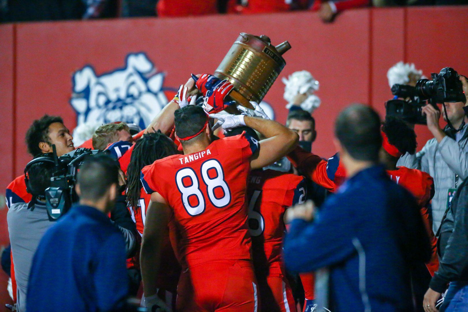 The Bulldogs celebrate their 23-14 victory over San Diego State as they lift the Oil Can Trophy, Saturday, Nov. 17, 2018. (Jose Romo/The Collegian)