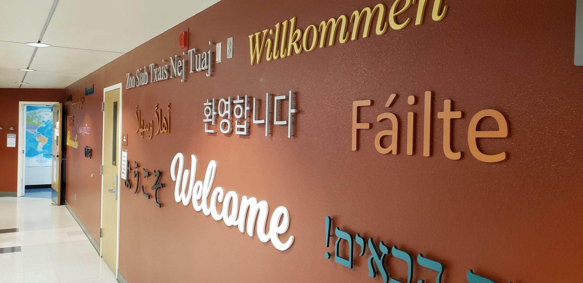 The wall outside the International Student Services and Programs office in the Kremen Building displays various translations of the word Welcome. (Seth Casey/The Collegian)