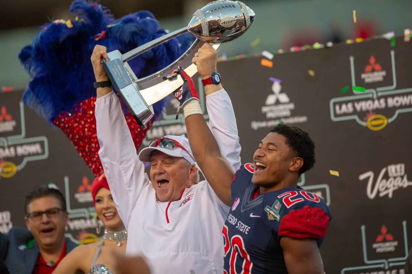 Fresno State head coach Jeff Tedford and 2018 Las Vegas Bowl MVP running back Ronnie Rivers celebrate as they raise the Las Vegas Bowl trophy after the Bulldog’s 31-20 victory over Arizona State at Sam Boyd Stadium on Dec. 15th , 2018.
Rivers rushed for 212 yards and two touchdowns in the victory. (Jose Romo/The Collegian)