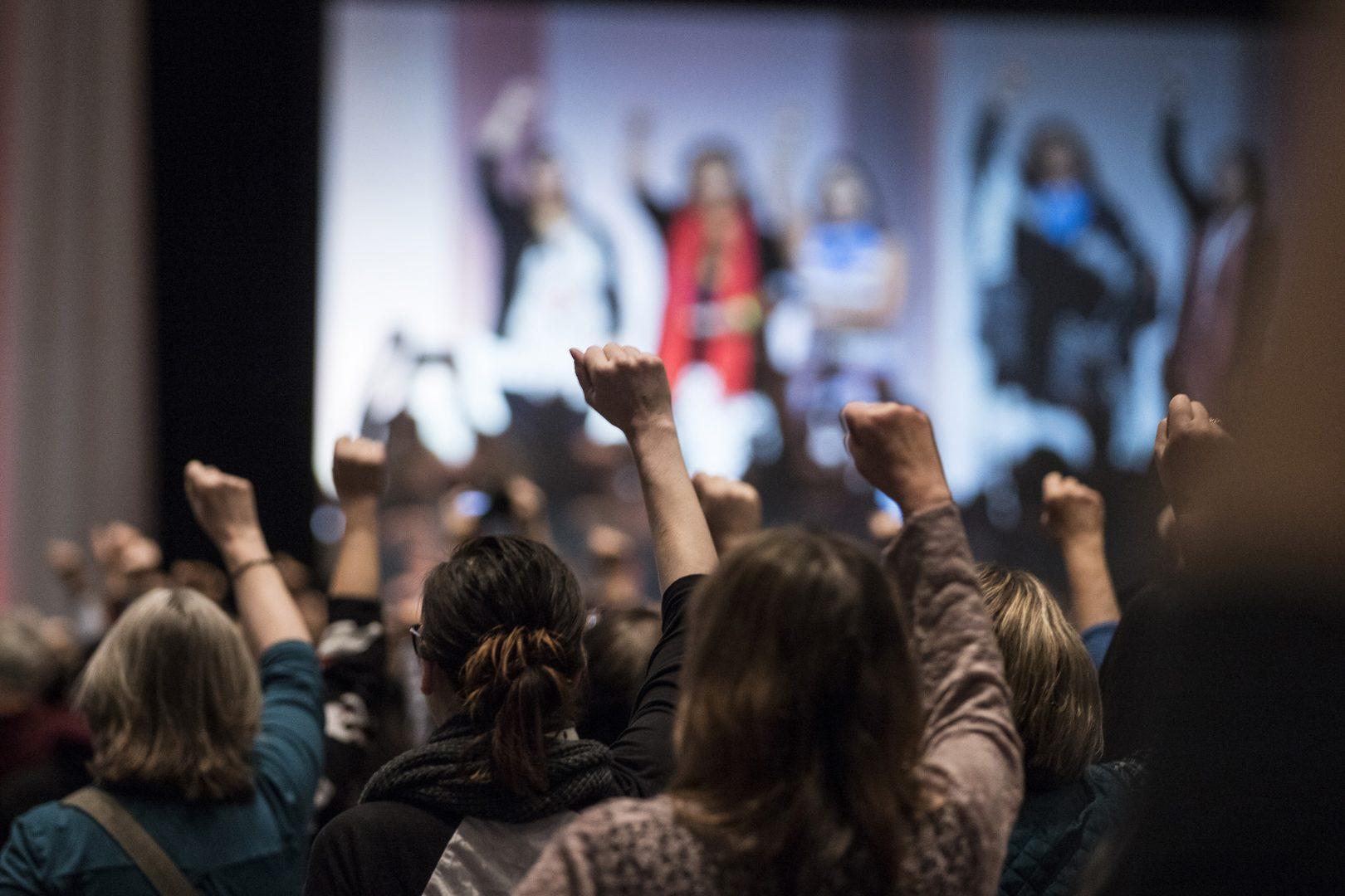 Attendees raise their fists as they hear the opening prayers song offered by five indigenous women during The Womens Convention at Cobo Center in downtown Detroit, Friday, Oct. 27, 2017. (Junfu Han/Detroit Free Press/TNS)