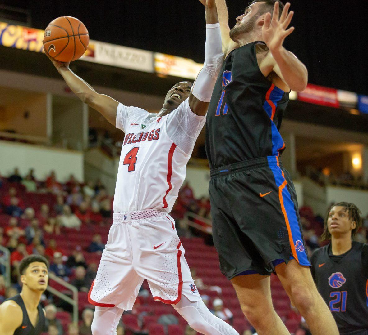 Fresno State guard Braxton Huggins goes up for a contested layup while defended by
Boise State’s Zach Haney during the Bulldogs’ 65-63 victory at the Save Mart Center on
Wednesday, Feb. 13, 2019. (Jose Romo Jr./The Collegian).