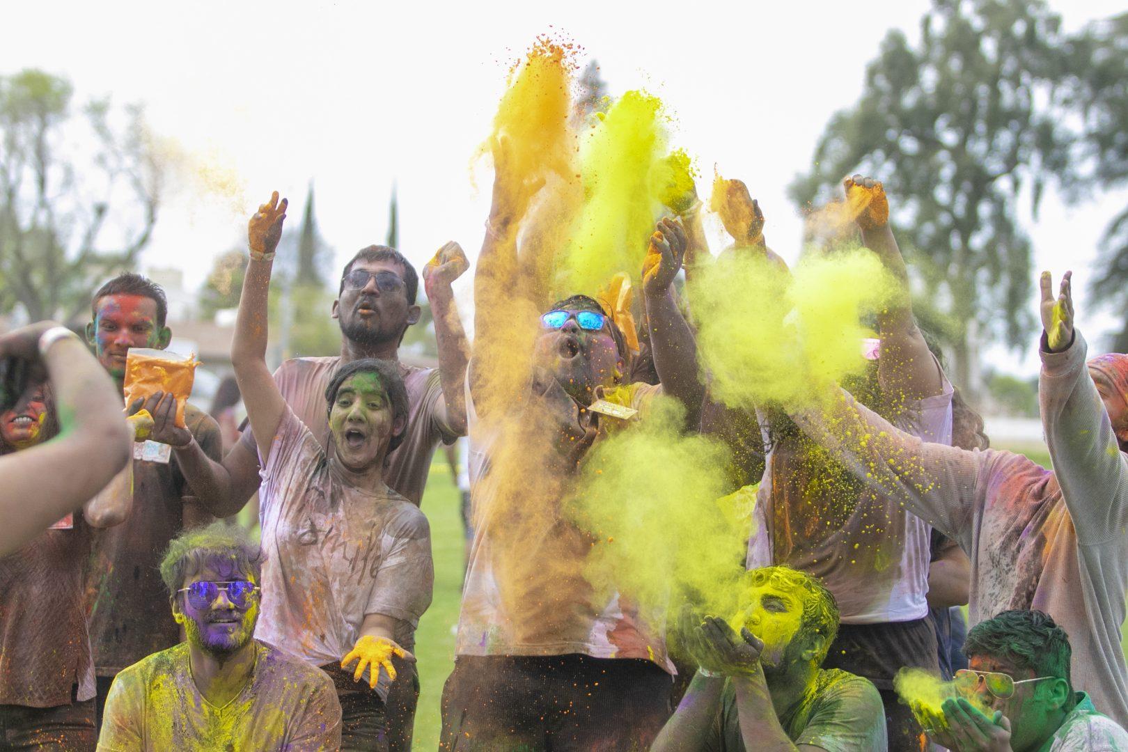 Students from Fresno States Indian Student Club throw colored powder as part of the Holi Festival Party at J.E. ONeill Park on March 22, 2019. (Larry Valenzuela/The Collegian)
