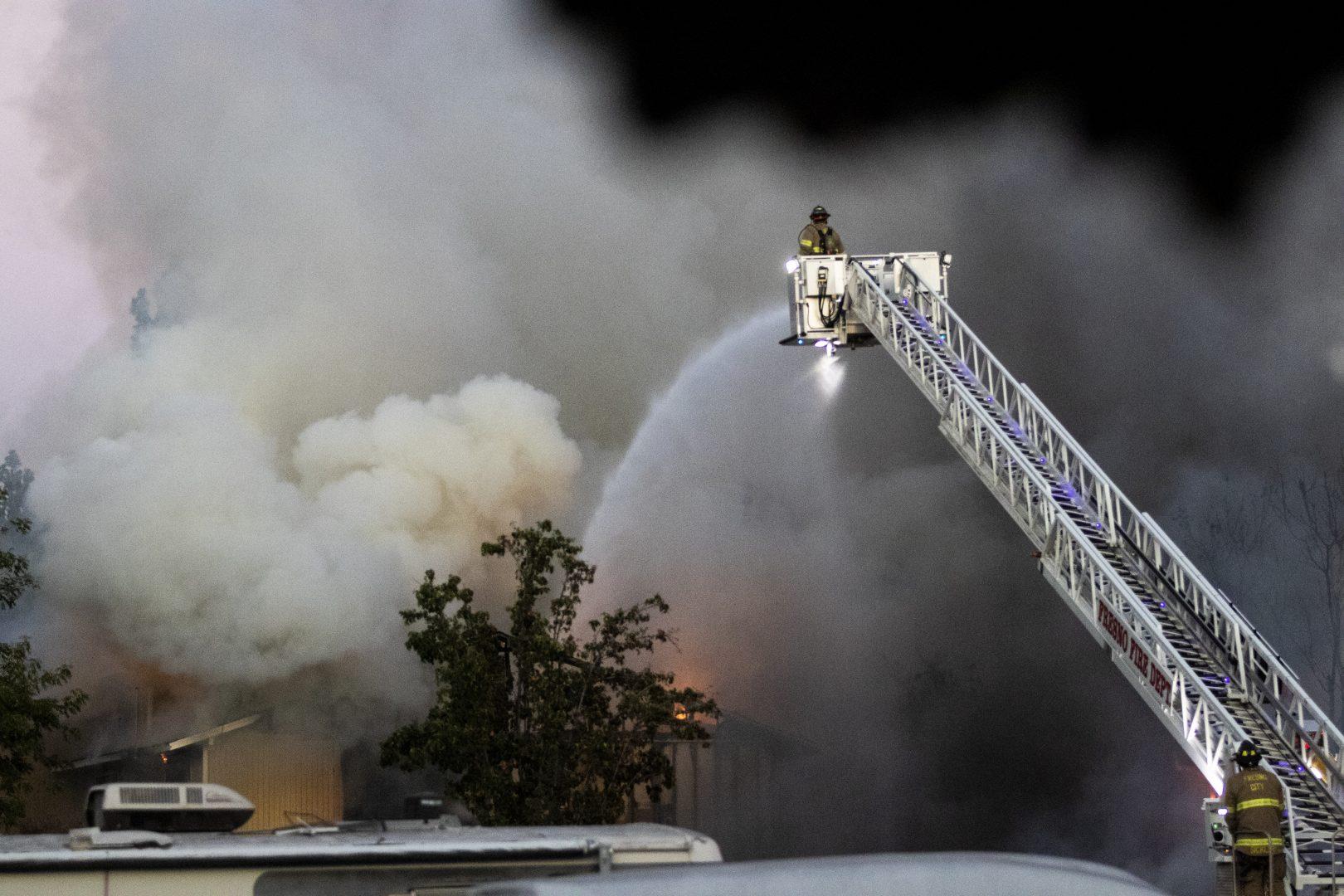Firefighters work to put out the blaze at the Maplewood Apartments complex just south of Fresno State on Aug 18. The fire displaced 15 students and damaged 14 apartment units. (Larry Valenzuela/The Collegian)