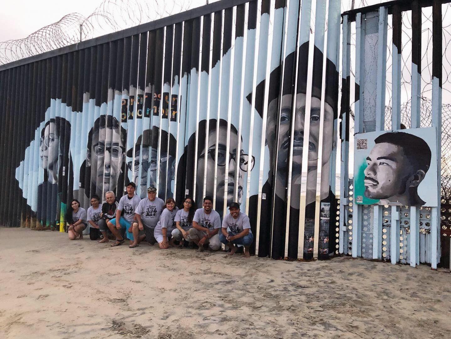 Volunteers pose for a photo in front of the completed mural on August 9, 2019, at Playas de Tijuana. (Courtesy of Lizbeth De La Cruz Santana)