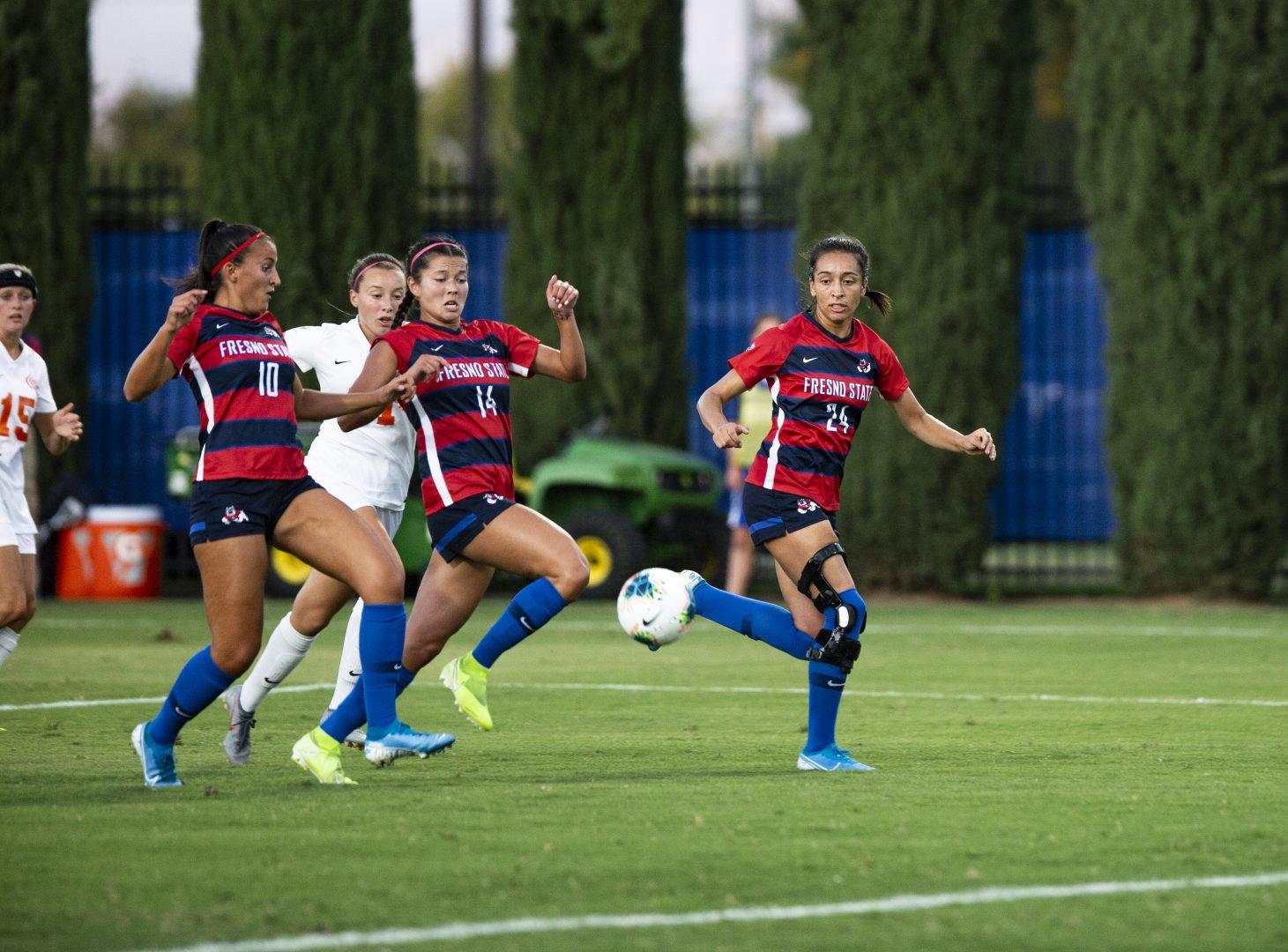 (From left to right) Fresno State soccer players Mariona Segales, Melissa Ellis and Emma Chivers running the ball down the field against University of the Pacific on Sunday, Sept. 1, 2019. (Larry Valenzuela/ The Collegian)