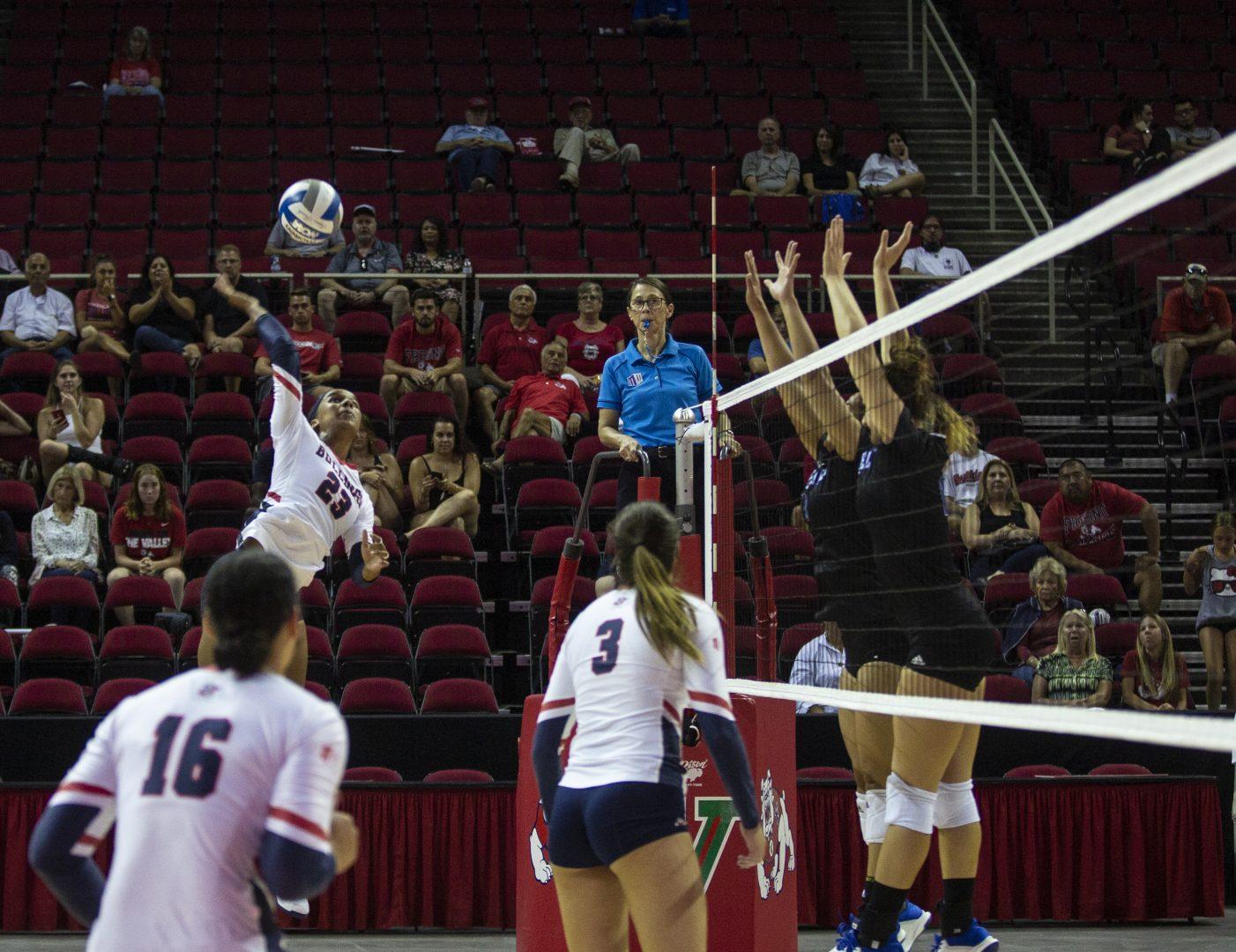 Outside hitter Amilya Thompson of Fresno State spikes the ball in front of her opponents during the Fresno State Invitational at the Save Mart Center on Thursday, Sept. 5, 2019. (Larry Valenzuela/The Collegian)