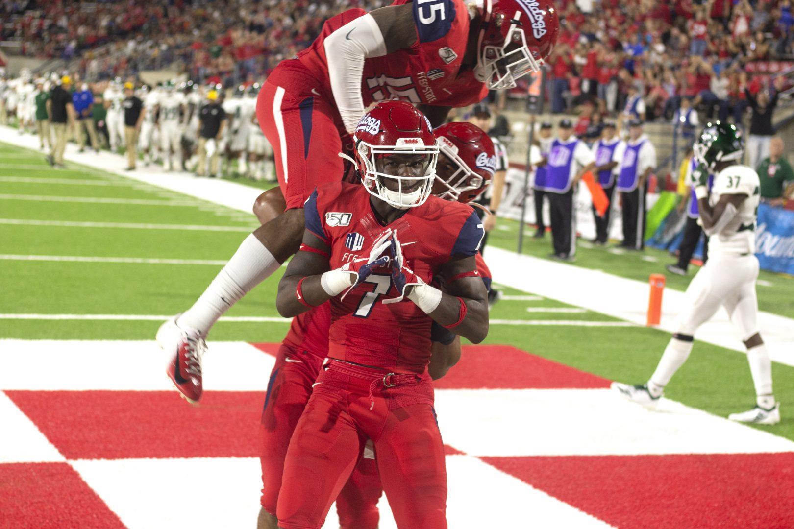 Fresno State wide receiver Derrion Grimm (center) celebrates with teammates after scoring a touchdown during a home game at the Bulldog Stadium on Saturday, Sept. 21, 2019. (Jorge Rodriguez/ The Collegian)