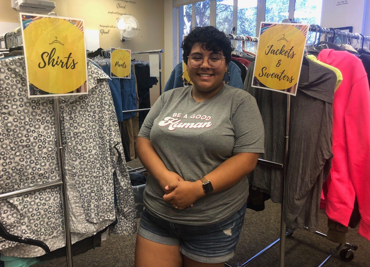 Cross Cultural and Gender Center graduate coordinator Kiana Medina stands in front of clothing racks for the Q Clothing Pop Up Closet in the Thomas Buildings Room 110 on Monday, Sept. 9, 2019. (Christina Tran/The Collegian)