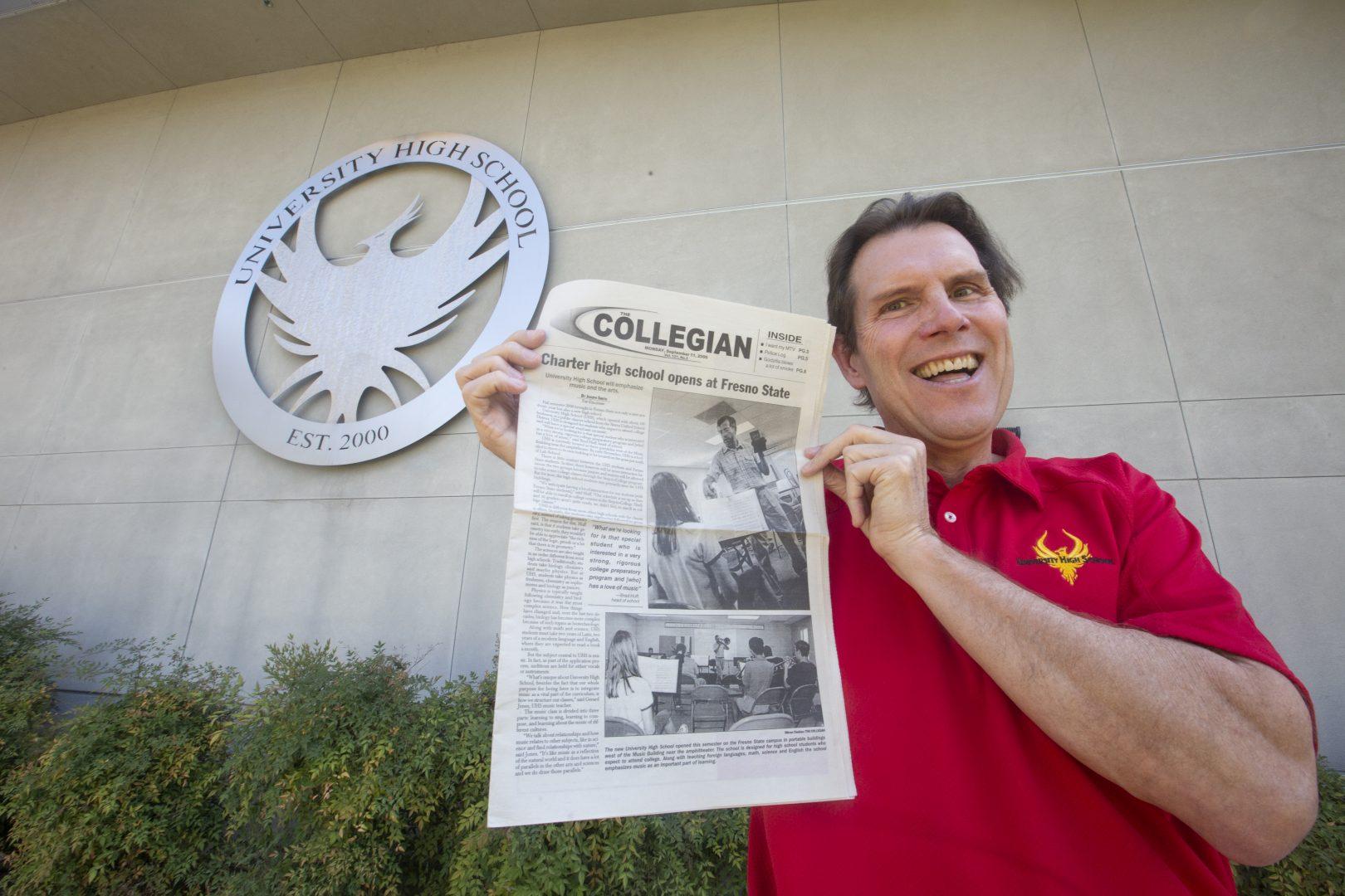 Head of school, James Bushman, holds a copy of The Collegian with the grand opening of University High School 20 years ago on Friday, Sept. 6, 2019. (Larry Valenzuela/The Collegian)
