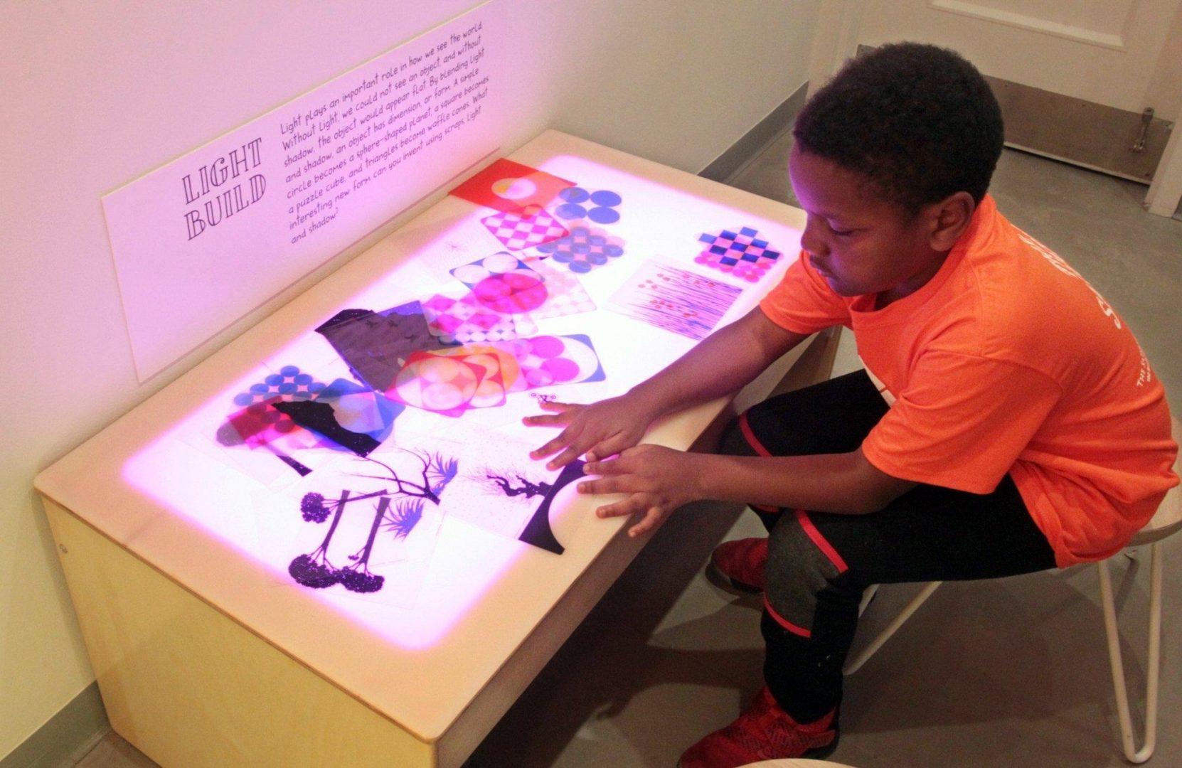 Reynard Richardson, 9 from the Salvation Army summer camp explores with the light table at Akron Art Museum's newly-opened Live Creative Studio on Friday June 7, 2019 in Akron, Ohio.  [Mike Cardew/Beacon Journal/Ohio.com]
