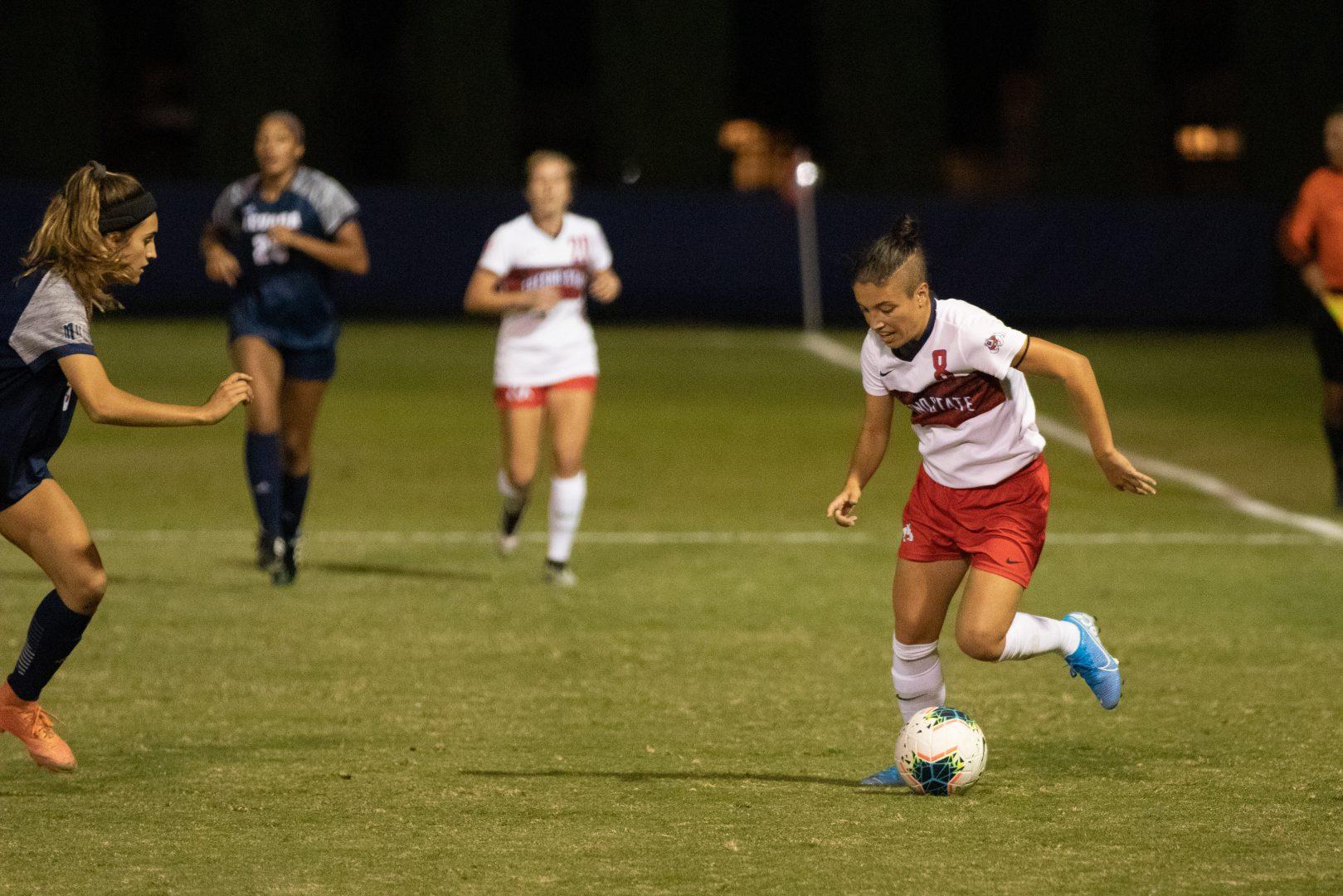 Fresno State midfielder Lorena Montanes takes on opponent during a home match against the University of Nevada Reno at the Soccer and Lacrosse Stadium on Thursday, Oct. 17, 2019. (Armando Carreno/The Collegian)