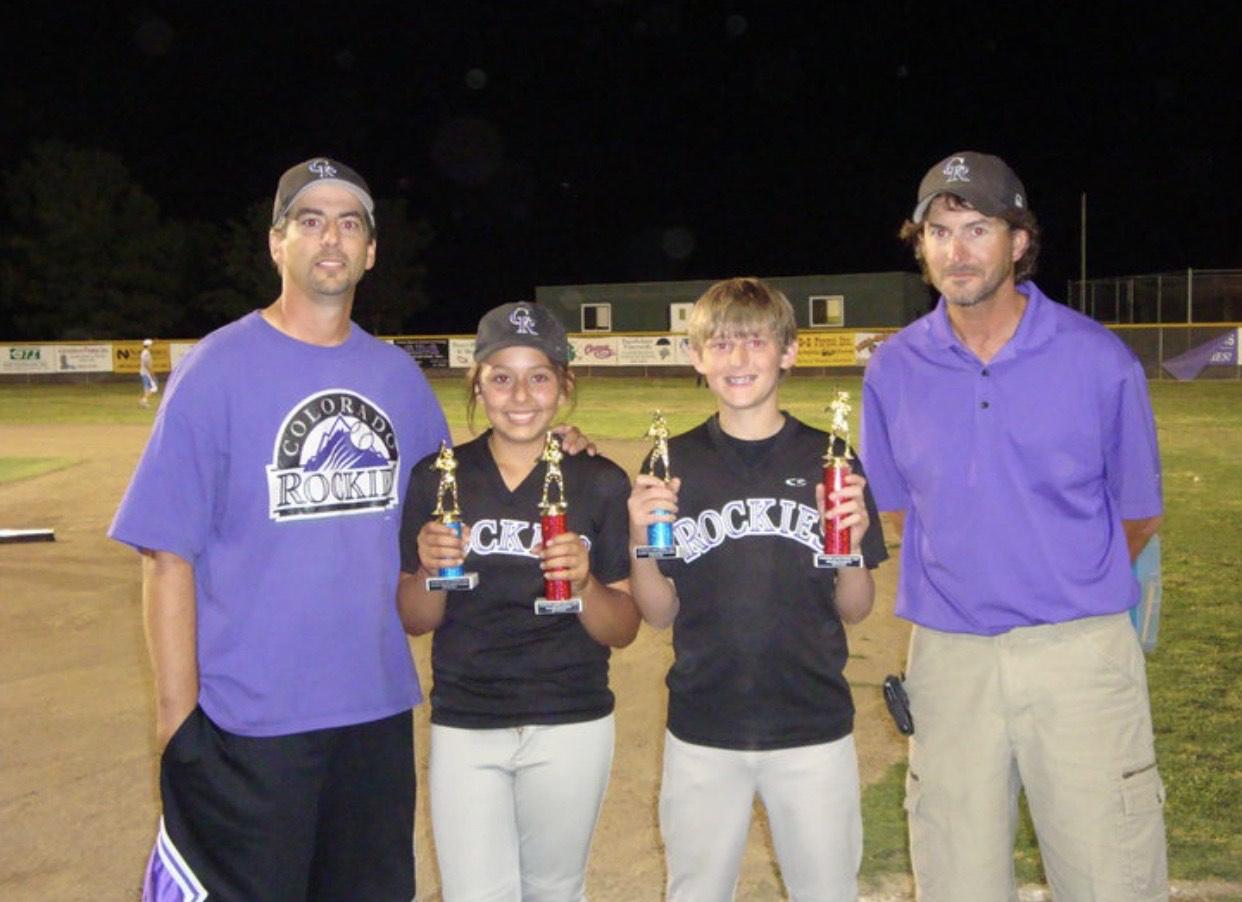 From left to right Mike Freitas, Anjanae Freitas, JD freitas and Tommy Freitas. Anjanae Freitas at 13 next to her father after winning her baseball little league series championship in May of 2000.