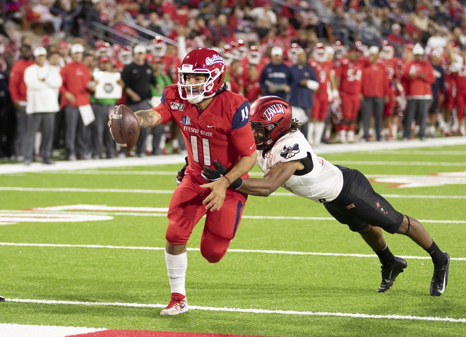Fresno State quarterback Jorge Reyna scrambles in for a touchdown against the University of Nevada Las Vegas during a home game at Bulldogs Stadium on Friday, Oct. 18, 2019. (Armando Carreno/The Collegian)