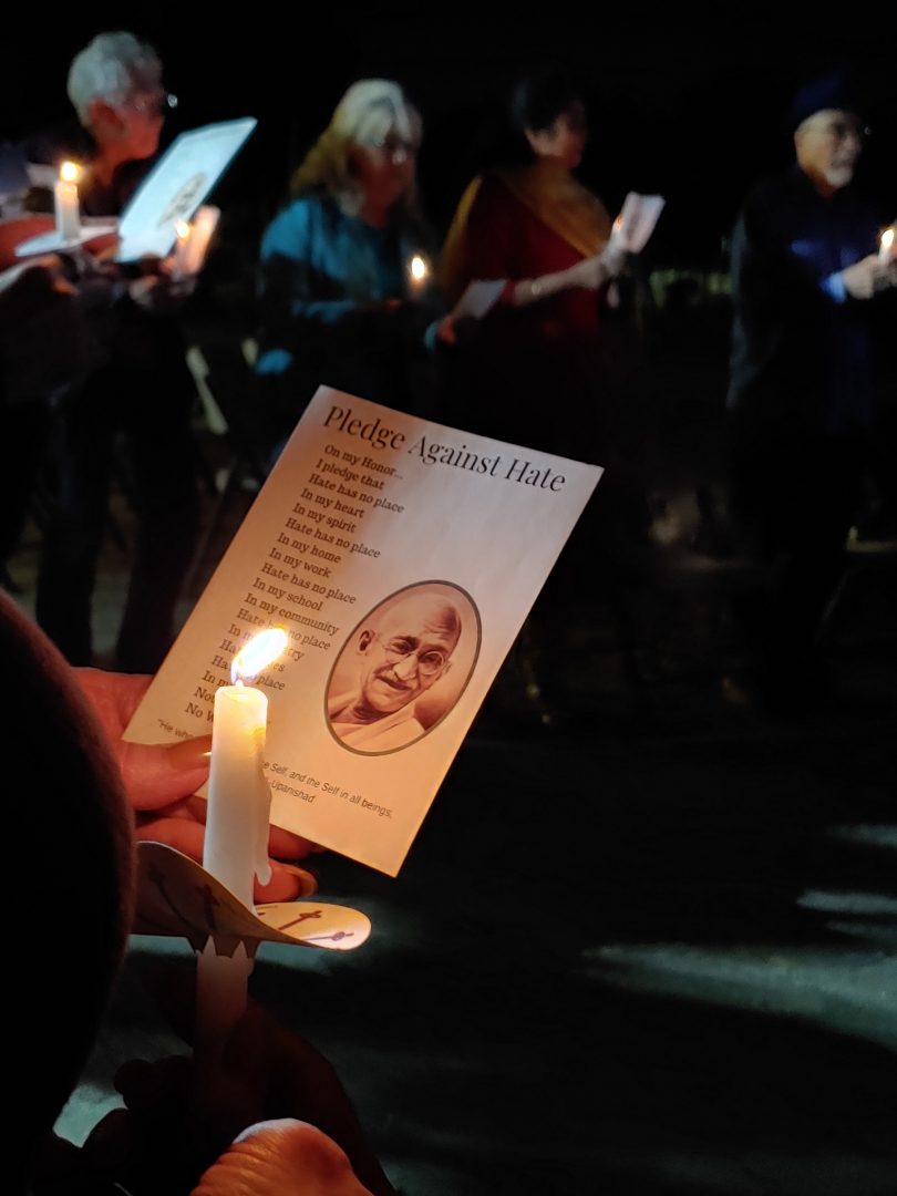 Attendees of Mahatma Gandhis 150th birthday celebration hold candles and recite the Pledge Against Hate at the Peace Garden on Wednesday, Oct. 2 (Jennifer Reyes/The Collegian)