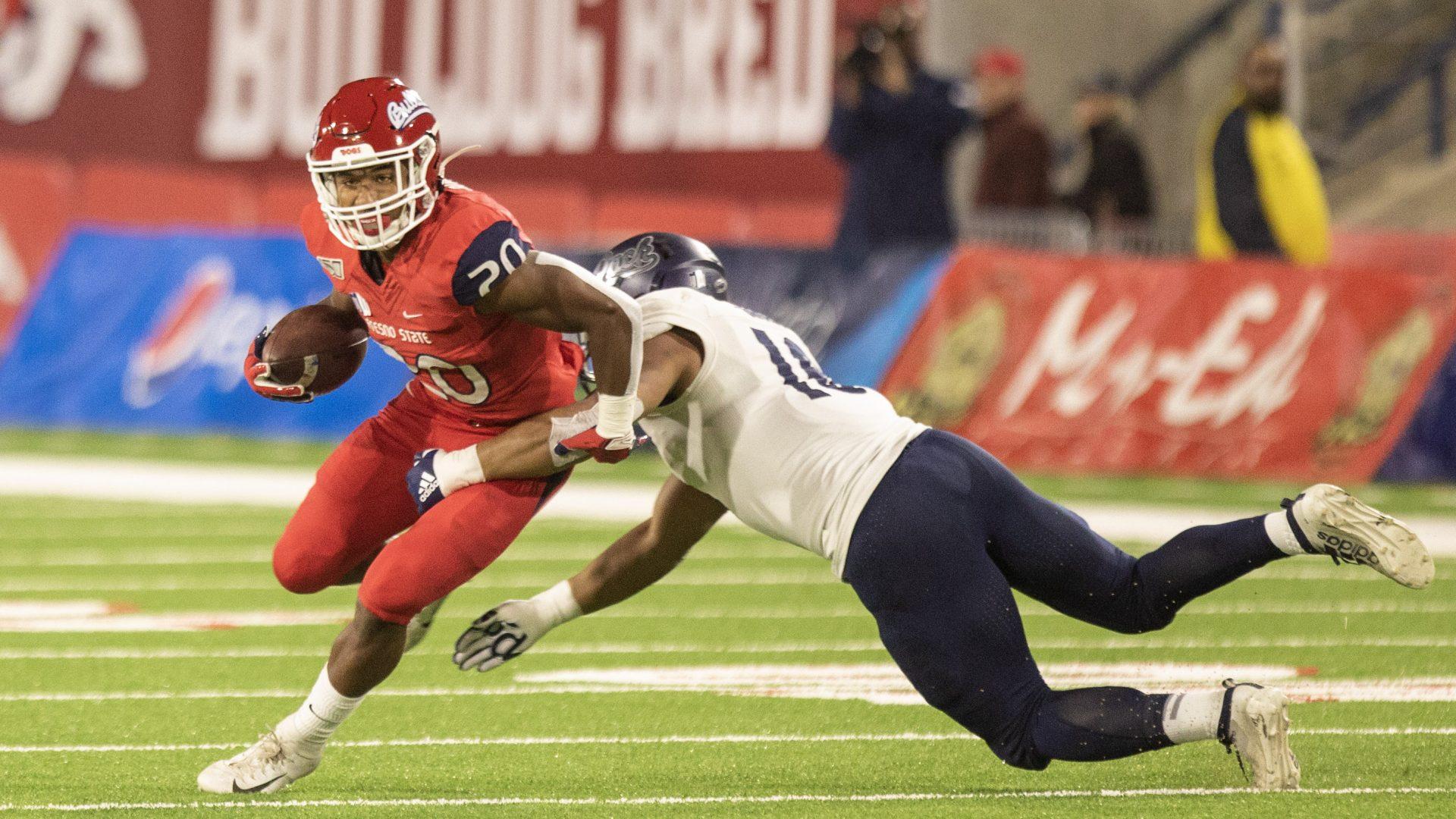  Fresno State running back Ronnie Rivers runs through Nevada defenders during the first half of a home match at Bulldog Stadium on Saturday, November 23, 2019 (Armando Carreno/The Collegian)