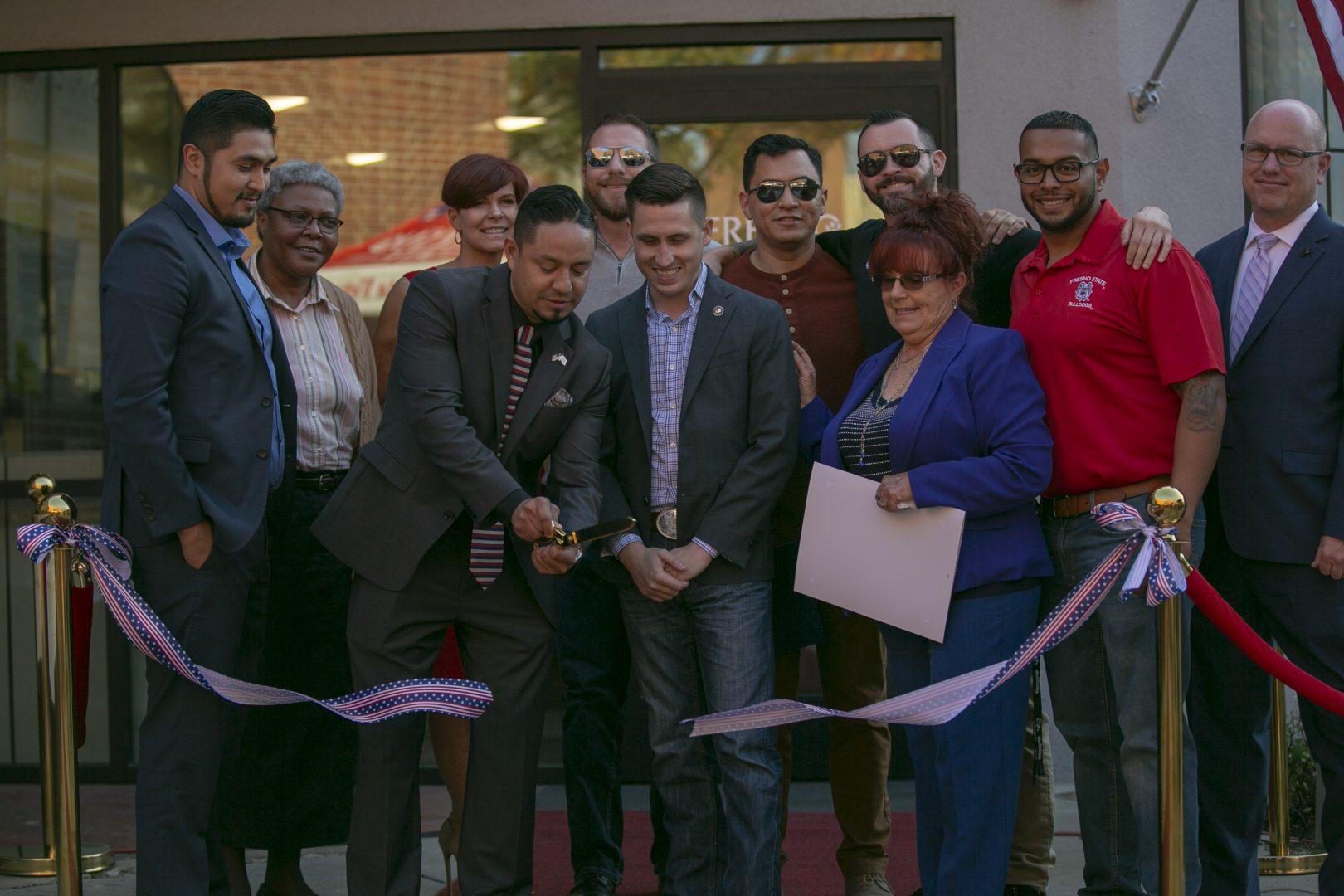 Faculty, staff and veteran students cut the ribbon during the grand opening of the Veterans Resource Center, located at the University Center room 101 on Friday, Nov. 15, 2019. (Anthony De Leon/ The Collegian)