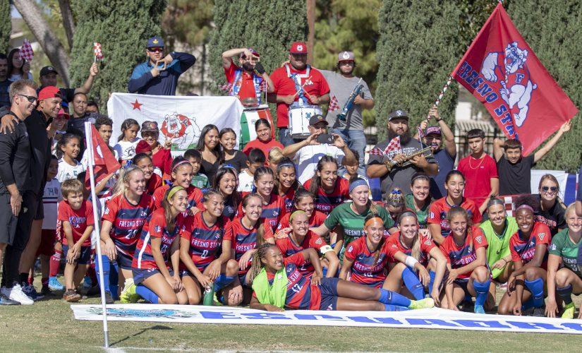 The Fresno State womens soccer team celebrate with the Escuadron supporters group during a 2-1 victory at the Soccer and Lacrosse Stadium on Sunday, Oct. 28, 2019. (Jorge Rodriguez/The Collegian)