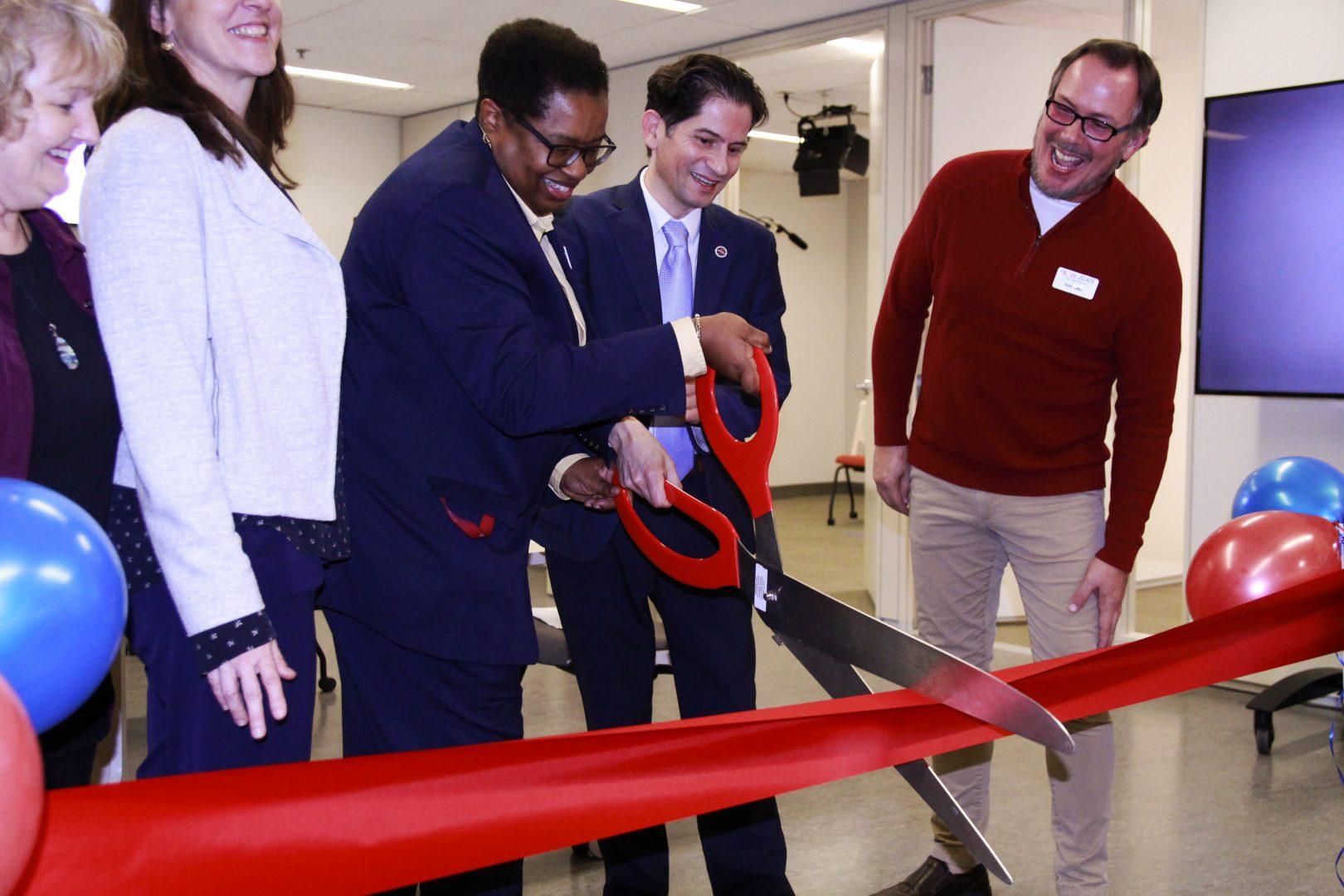 From center, Library Dean Delritta Hornbuckle, Fresno State Provost Saul Jimenez-Sandoval and media specialist Terry Lewis cut the ribbon for the launch of the Video Studios in the Henry Madden Library on Monday, Jan. 27, 2020.