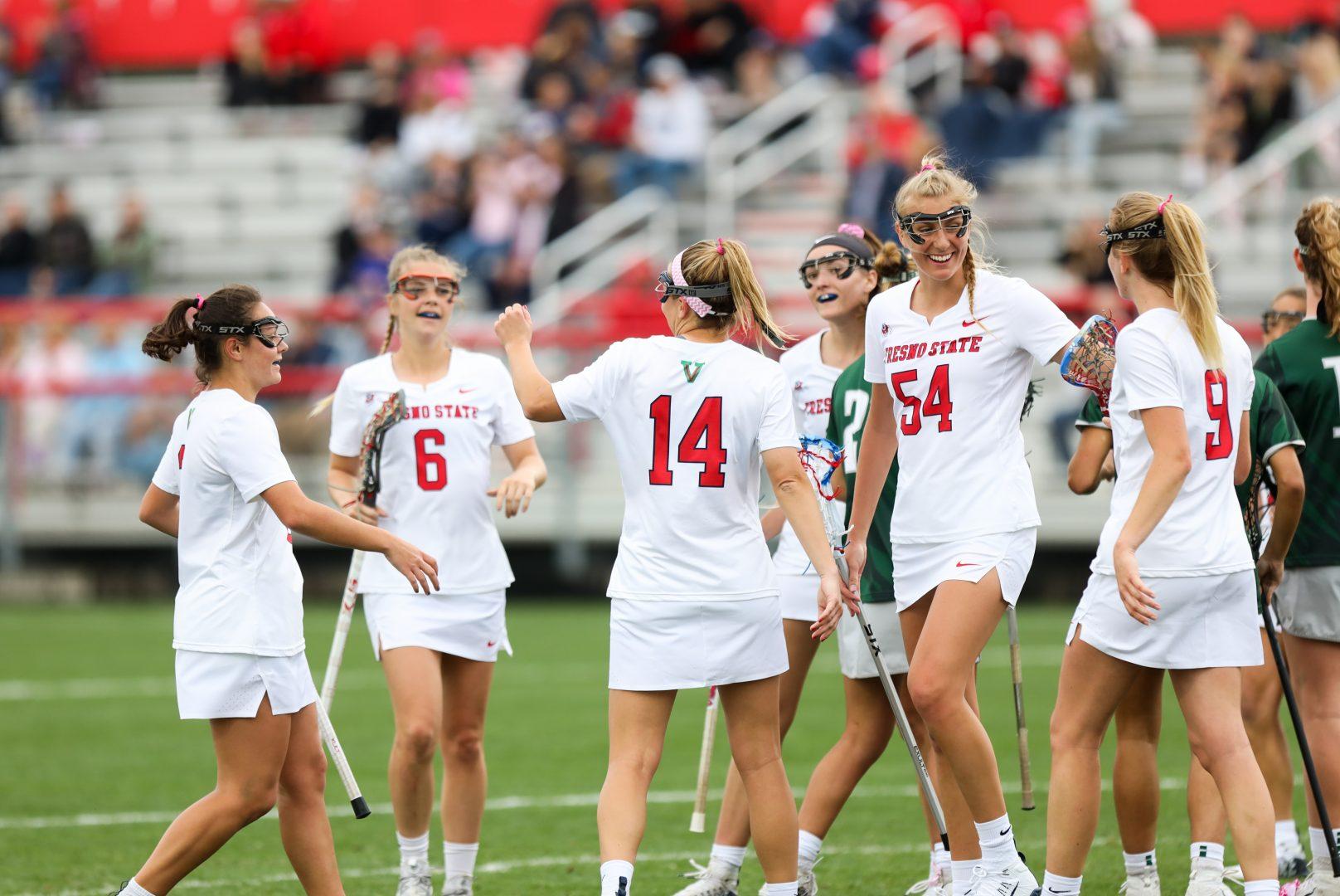 Fresno State’s women’s lacrosse team celebrates a goal made during the first half of the Bulldog’s 21-13 victory over Stetson at Fresno State Soccer & Lacrosse Stadium on Feb. 22, 2020. (Vendila Yang/The Collegian)