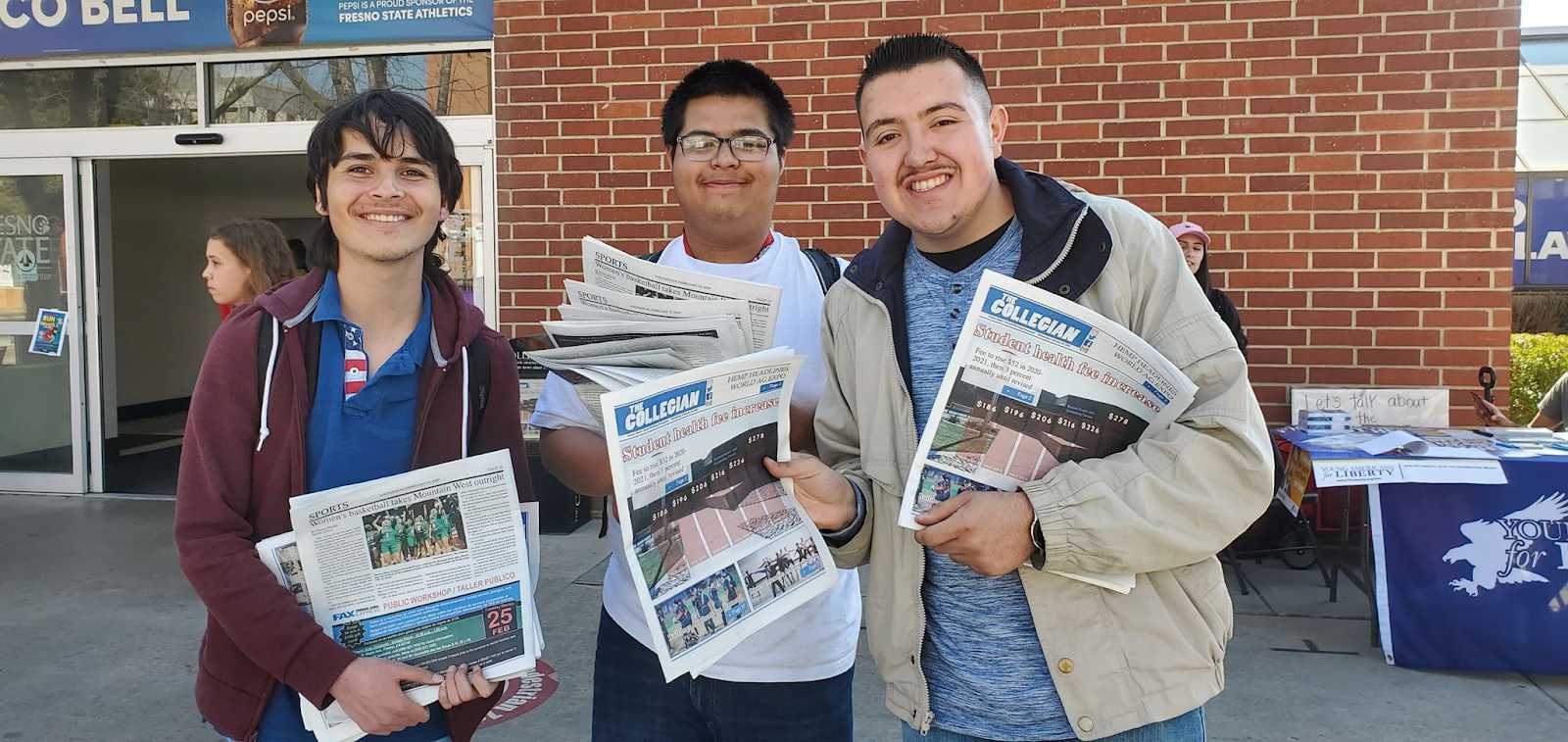 From left, Mason Frazier, Ulises Martinez and Diego Rodriguez from the TARGET program outside the University Center, passing out The Collegian on Wednesday, Feb. 19, 2020. (Galcy Lee/ The Collegian)