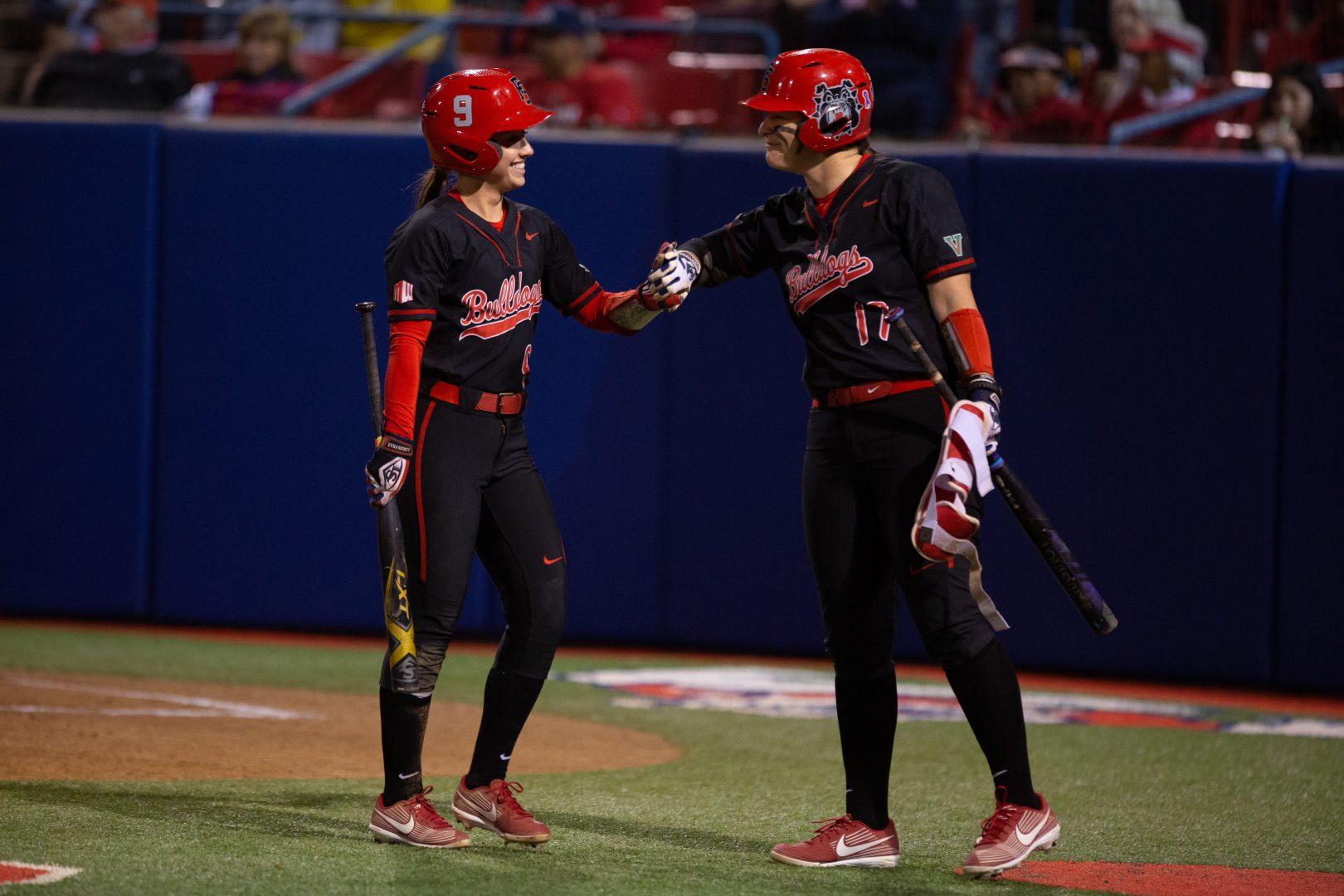 Miranda Rohleder (left) celebrates teammate Kelcey Carrasco (right) after scoring the go-ahead run, giving the Bulldogs a 3-2 lead over North Dakota State at Margie Wright Diamond on Friday, March 7, 2020. (Armando Carreno/The Collegian)