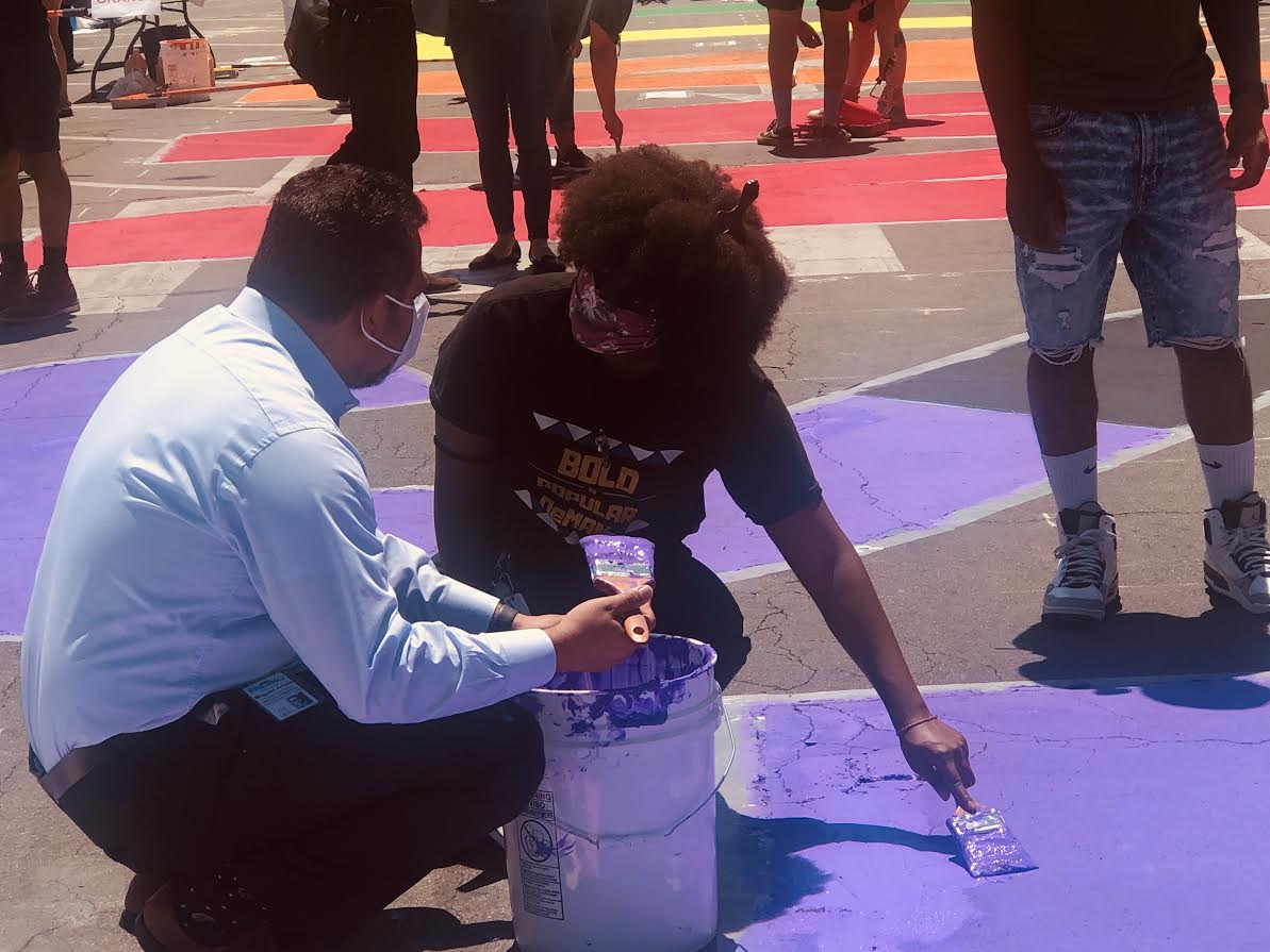 Fresno City Council President Miguel Arias (left) and Fresno State NAACP President D’Aungillique Jackson (right) helping contribute to the Black Lives Matter painting in front of City Hall on June 18, 2020. (Anthony De Leon/The Collegian)