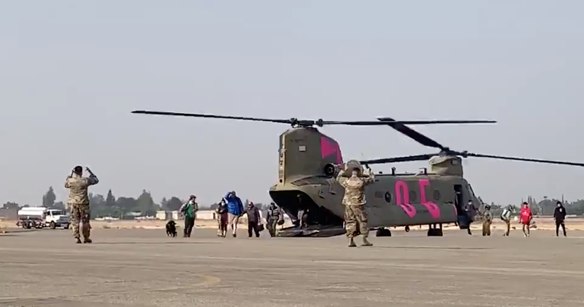 46 people and four dogs arriving at the Fresno Yosemite International Airport after being rescued from Lake Edison by a Stockton-based Cal Guard CH-47 Chinook helicopter. (Courtesy Department of Defense)