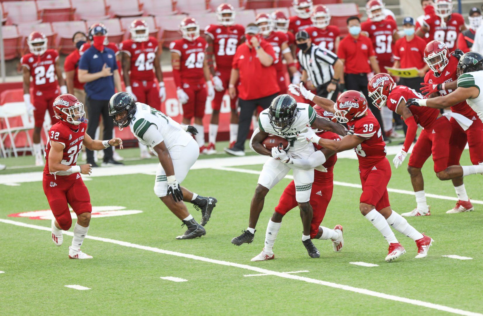Defensive back Evan Williams (32) goes in for a tackle against Hawaii Rainbow’s running back Miles Reed (4) during the first half of the game on October 24, 2020, at Bulldog Stadium. (Vendila Yang/The Collegian)