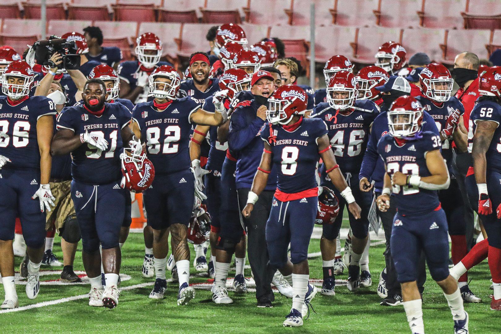 Fresno State’s head coach Kalen Deboer celebrates with the team after winning the football game against Colorado State Rams on October 29, 2020, at Bulldog Stadium. (Vendila Yang/ The Collegian)