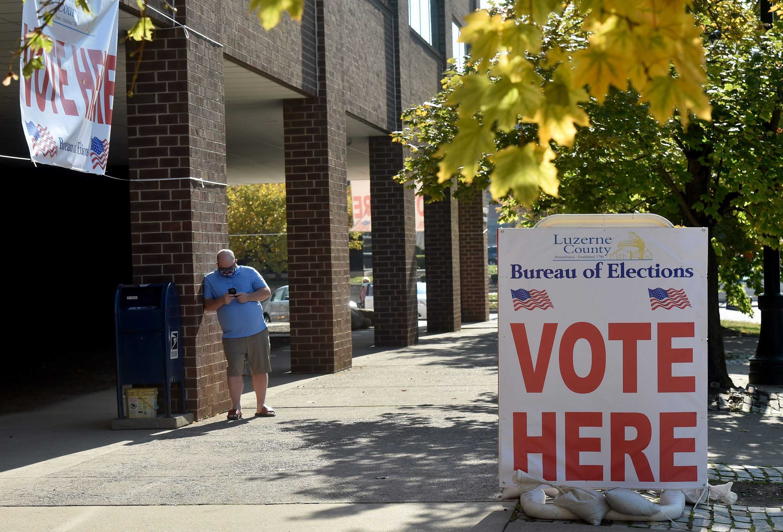 A man waits outside the Luzerne County Board of Elections where people drop off and request for mail-in ballots in Wilkes-Barre, Pennsylvania, on October 22, 2020. (Courtesy Tribune News Service)